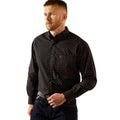 Man wearing a black patterned shirt on a white background
