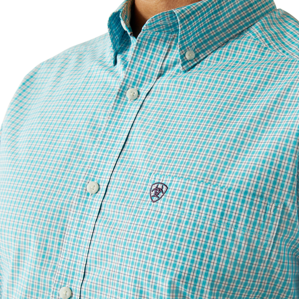 Close-up of a turquoise checkered shirt with a brand logo on a white background