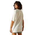 Woman wearing a white oversized t-shirt on a white background