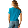 Woman wearing a blue t-shirt with 'COWGIRL' text on a white background