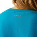 Woman wearing a blue t-shirt with 'COWGIRL' text on a white background