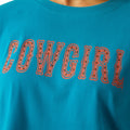 Woman wearing a blue t-shirt with 'COWGIRL' text on a white background