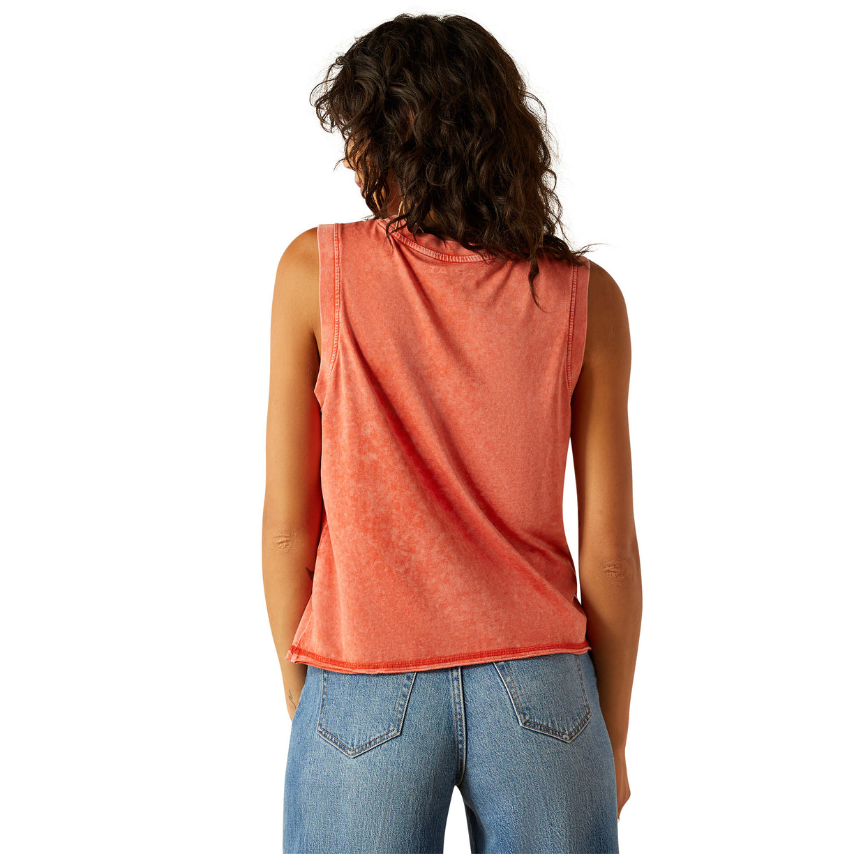 Person wearing a sleeveless orange top and blue jeans on a white background