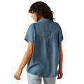 Woman wearing a blue denim shirt on a white background