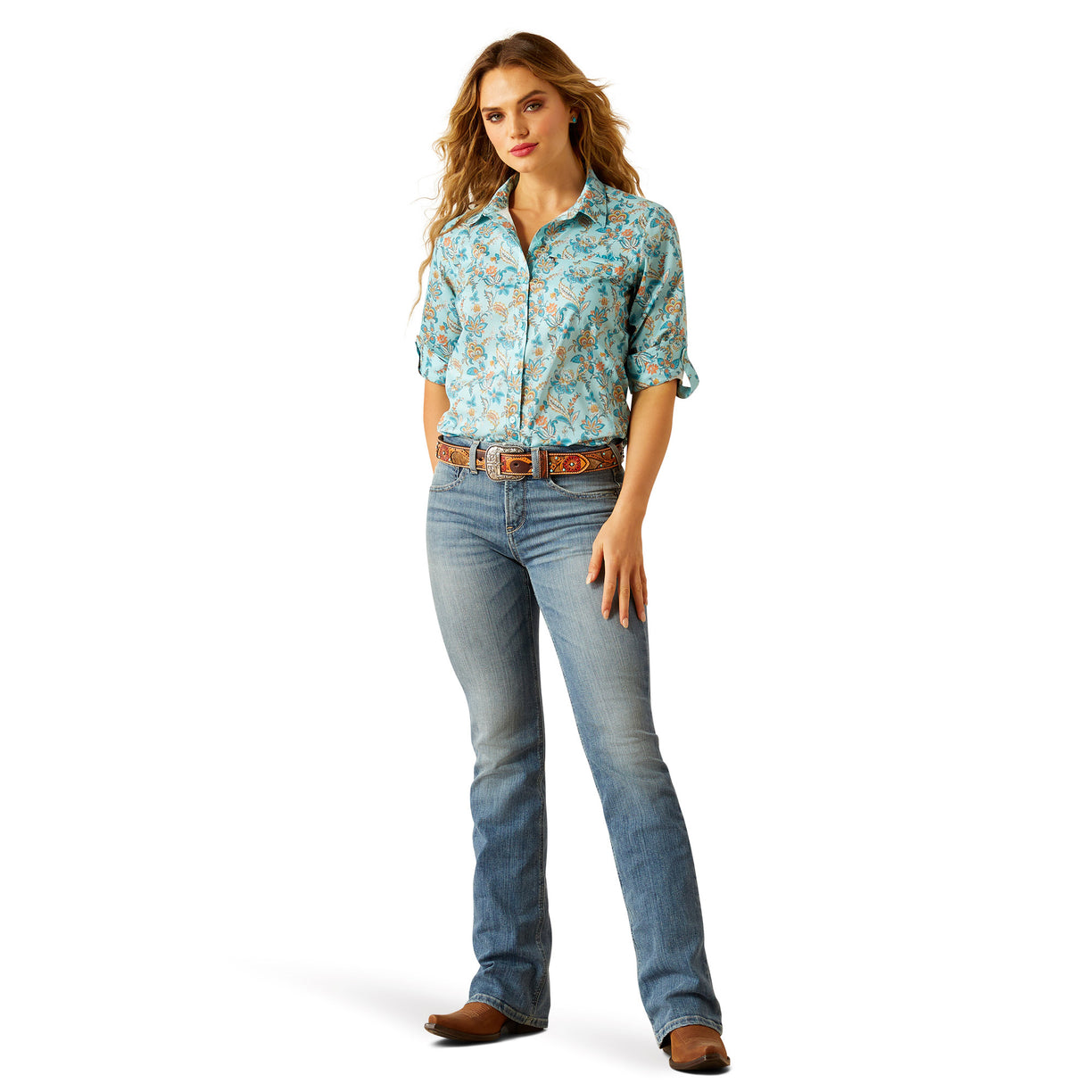 Woman wearing a floral shirt and jeans on a white background