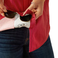 Person holding sunglasses with a white case featuring a black outline of sunglasses, against a red and white striped shirt.