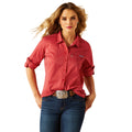 Woman wearing a red striped shirt and blue jeans on a white background