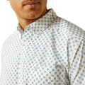 Man wearing a white shirt with blue floral pattern on a white background