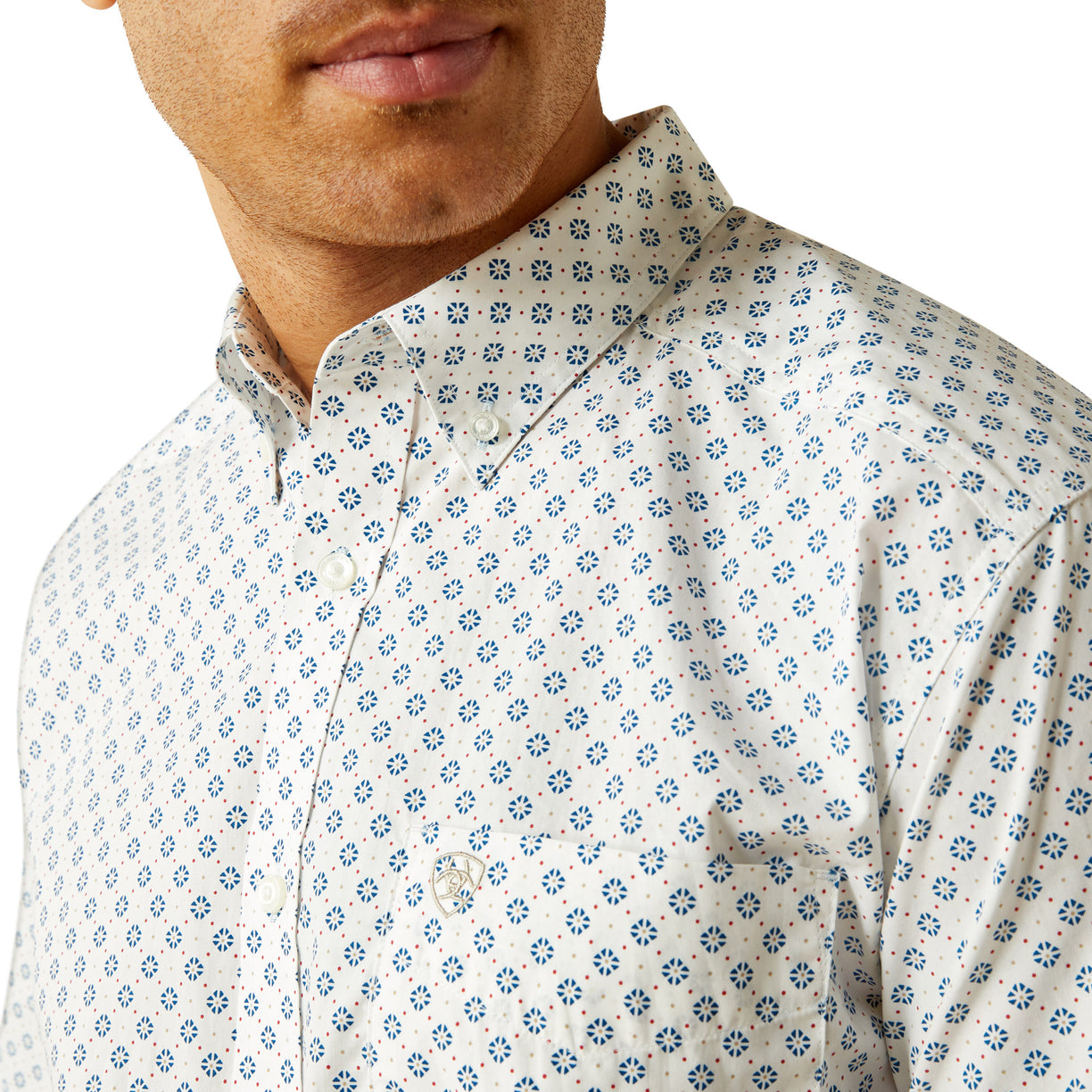 Man wearing a white shirt with blue floral pattern on a white background