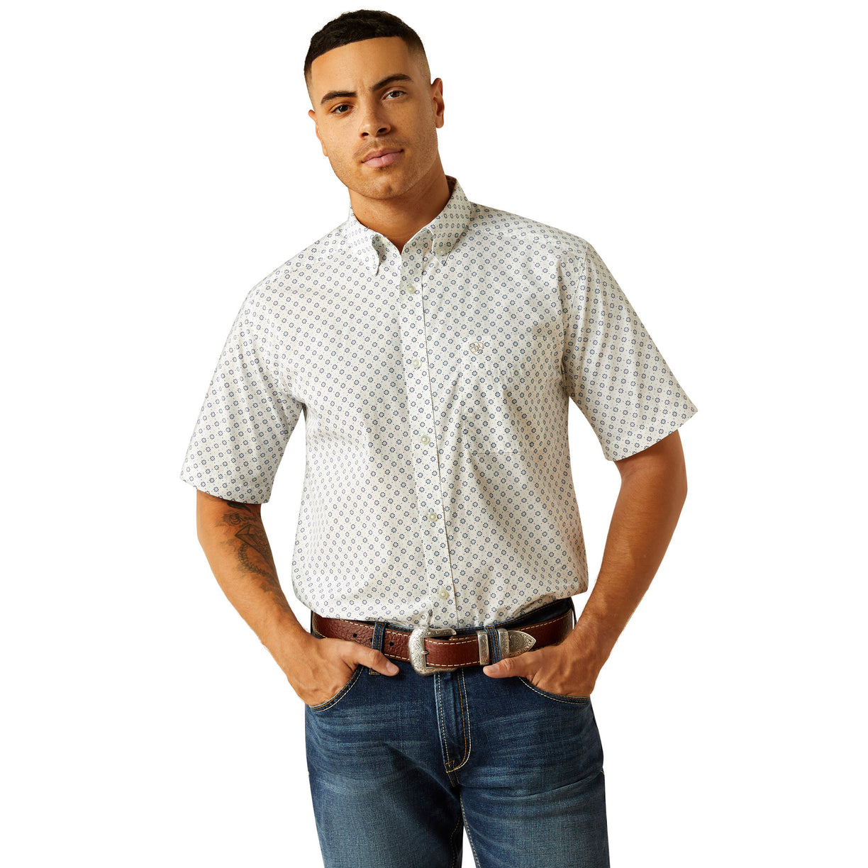Man wearing a patterned shirt and jeans on a white background