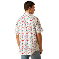 Man wearing a colorful patterned shirt on a white background