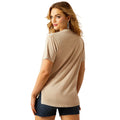 Woman wearing a beige t-shirt and black shorts on a white background