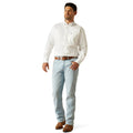 Man wearing a white dress shirt and light blue jeans on a white background