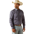 Man wearing a gray Ariat shirt, light blue jeans, and a cowboy hat on a white background