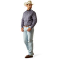 Man wearing a gray shirt, light blue jeans, and a cowboy hat on a white background