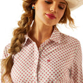Woman wearing a floral patterned shirt with a plain background