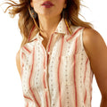 Woman wearing a sleeveless striped shirt and denim with a cowboy hat on a white background