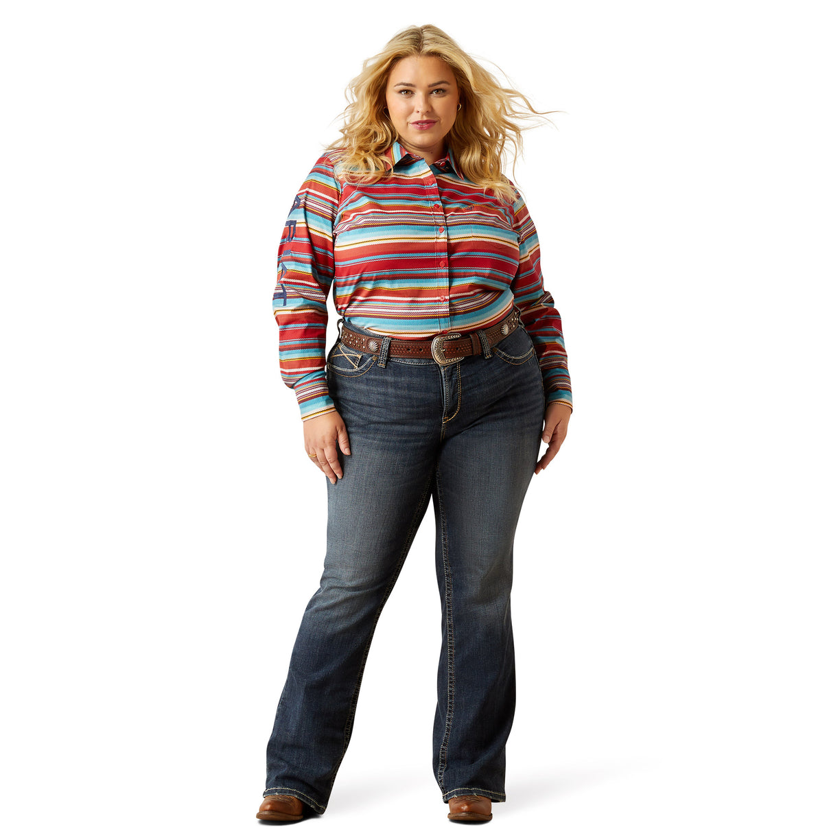 Woman wearing a colorful striped shirt and blue jeans on a white background
