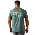 Man wearing a green Ariat t-shirt with a flag design on the back against a white background