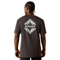 Person wearing a dark gray t-shirt with Ariat logo on the back, on a white background
