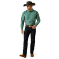 Man wearing a green checkered shirt, black cowboy hat, and dark jeans on a white background