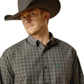 Man wearing a plaid shirt and cowboy hat on a white background
