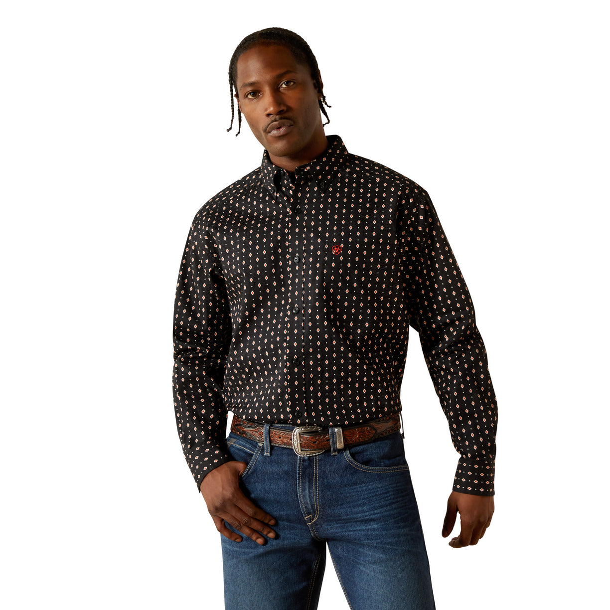 Man wearing a black patterned shirt and blue jeans on a white background