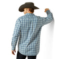 Man wearing a blue plaid shirt and cowboy hat on a white background
