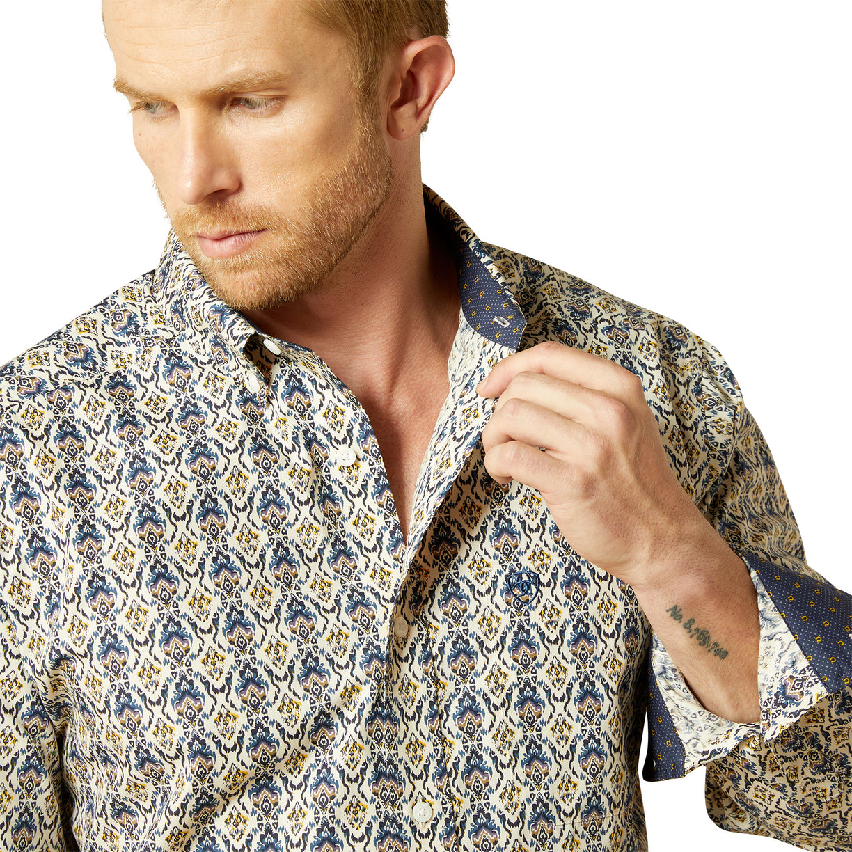 Man wearing a patterned shirt on a white background