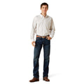 Man wearing a white button-up shirt and blue jeans on a white background