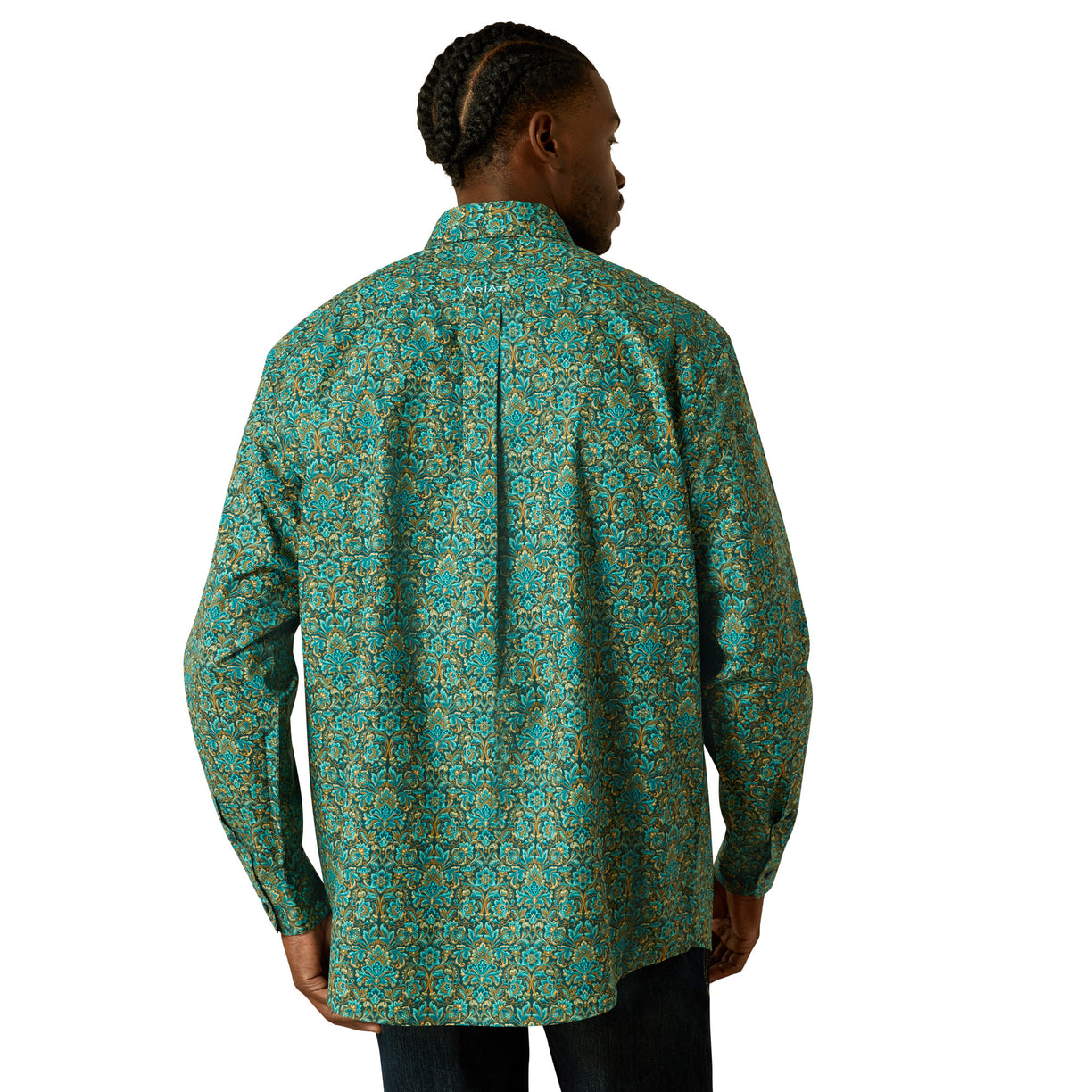 Person wearing a green patterned shirt on a white background