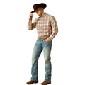 Man wearing a plaid shirt, jeans, and a cowboy hat on a white background