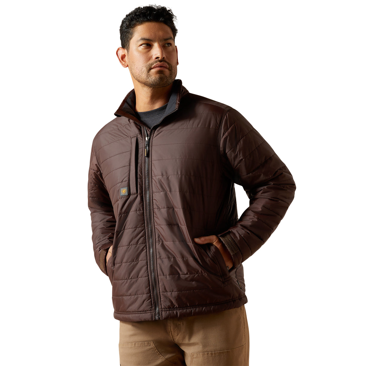 Man wearing a brown quilted jacket on a white background