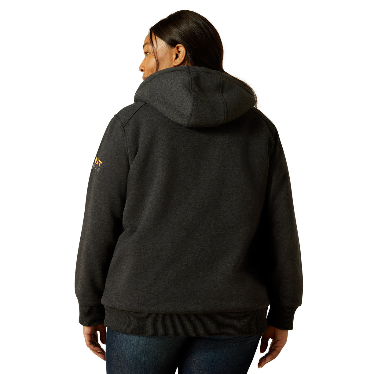 Person wearing a black hoodie with a brand logo on the back, standing against a white background