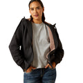 Woman wearing a black jacket with pink lining on a white background