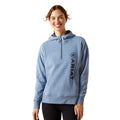 Woman wearing a blue hoodie with Ariat logo on a white background