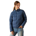 Woman wearing a blue puffer jacket on a white background