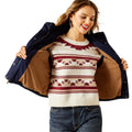 Woman wearing a patterned sweater with a navy jacket over her shoulders on a white background