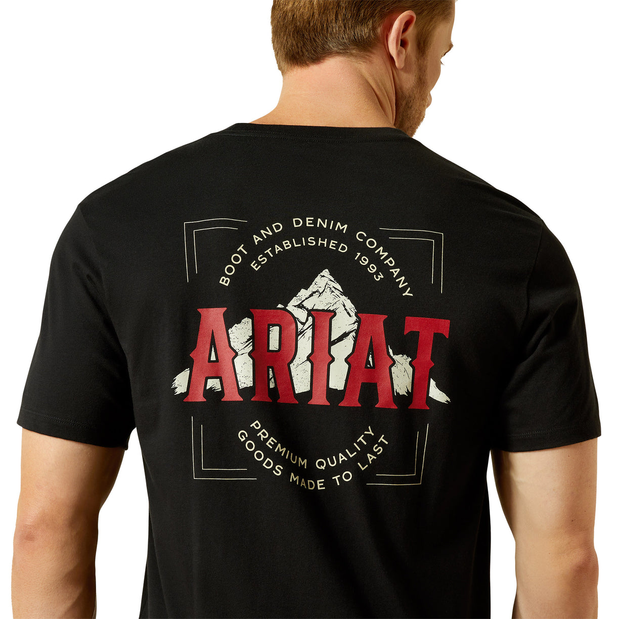 Man wearing a black t-shirt with Ariat logo and branding on the back