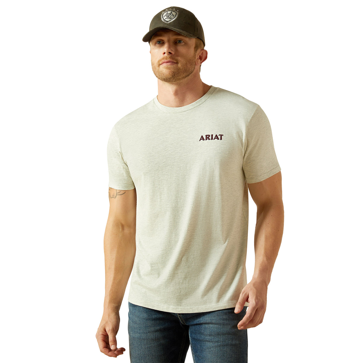 Man wearing a beige Ariat t-shirt and cap on a white background