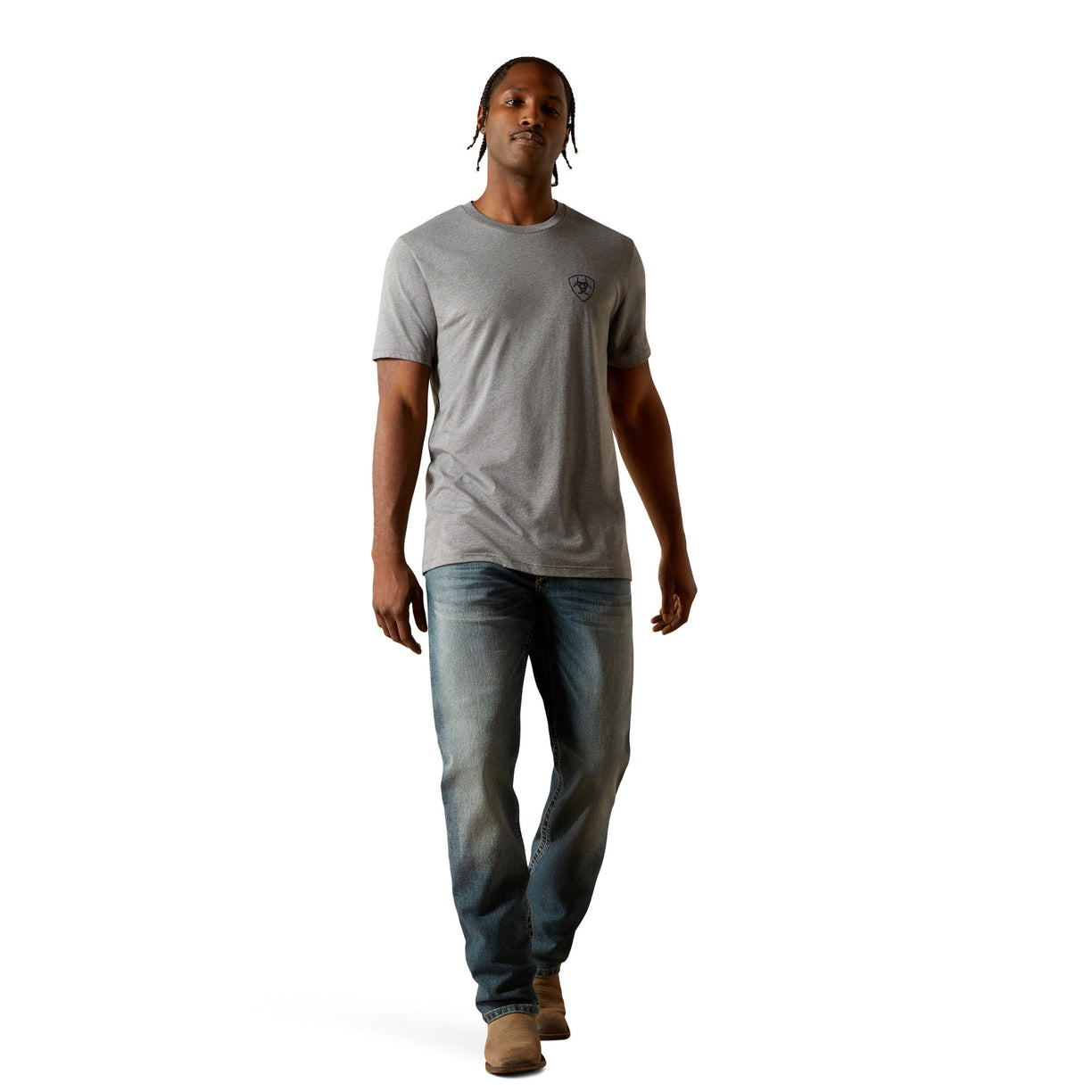 Man wearing a gray t-shirt and blue jeans on a white background