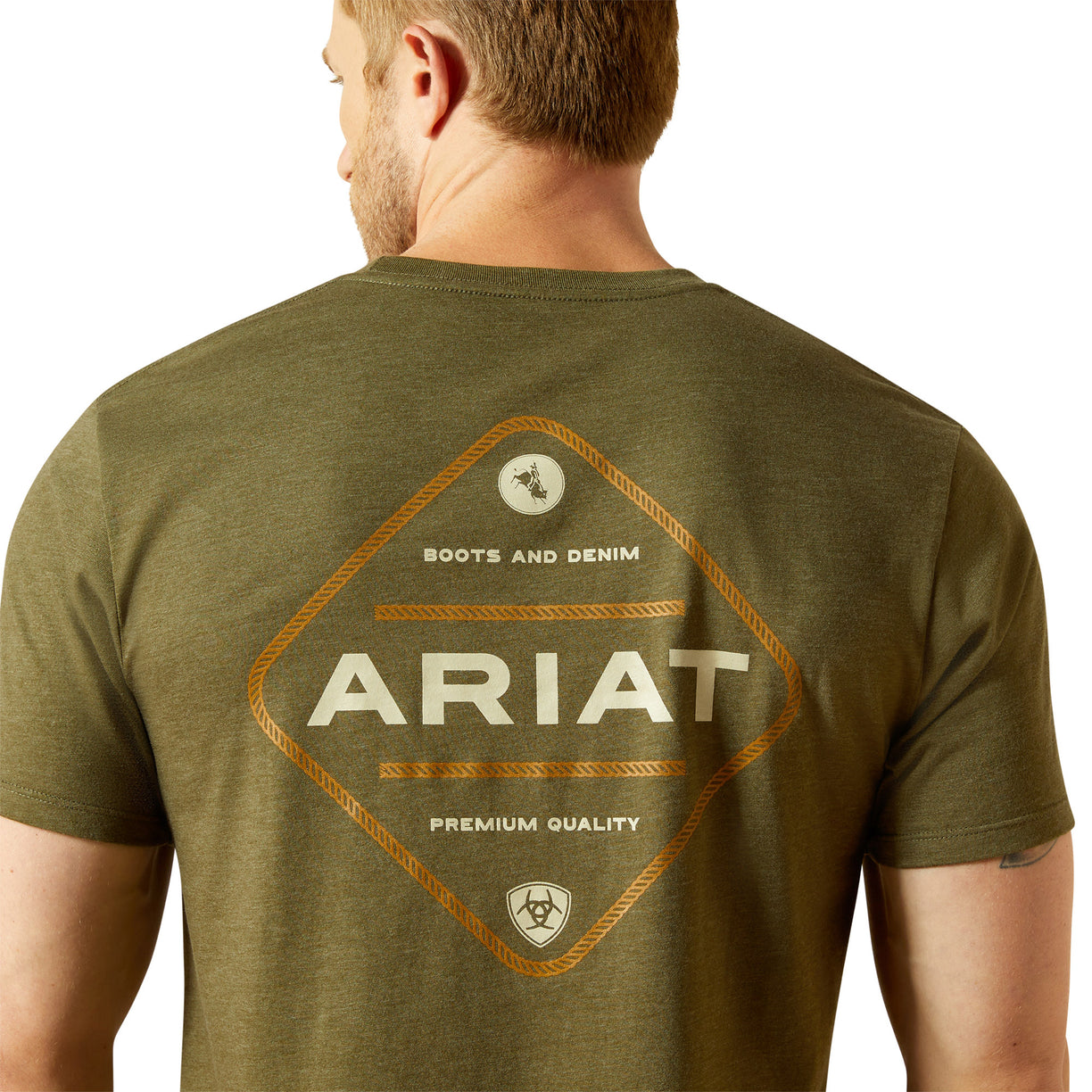 Man wearing an olive green Ariat t-shirt with branding on the back.