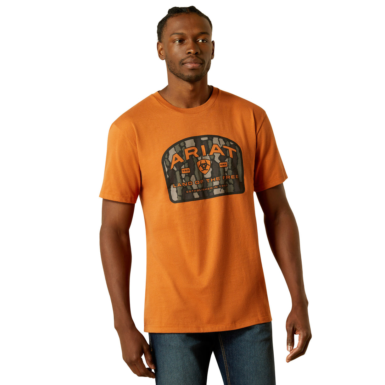 Man wearing an orange t-shirt with a logo on a white background