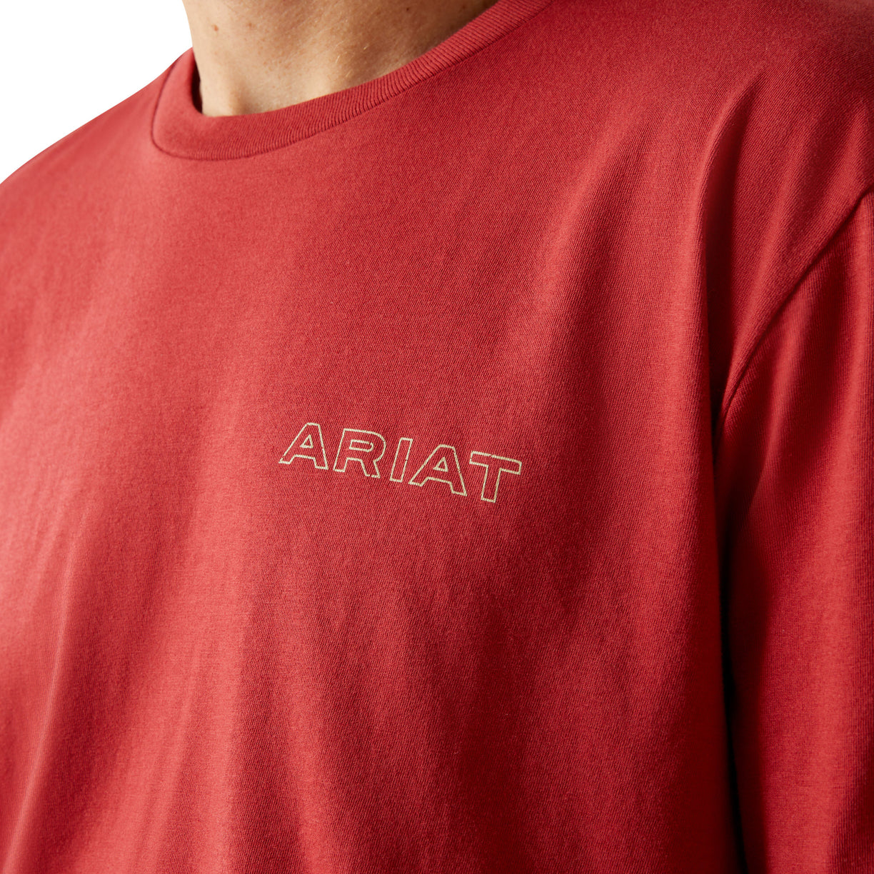 Red shirt with 'ARIAT' logo on a white background