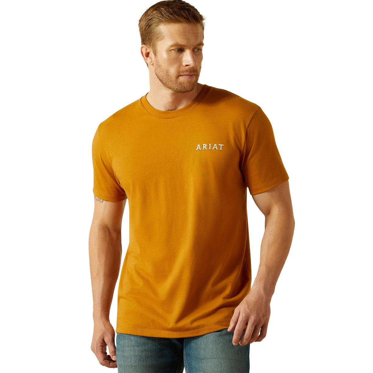 Man wearing a mustard yellow t-shirt with 'Ariat' logo on a white background