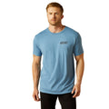 Man wearing a light blue Ariat t-shirt on a white background