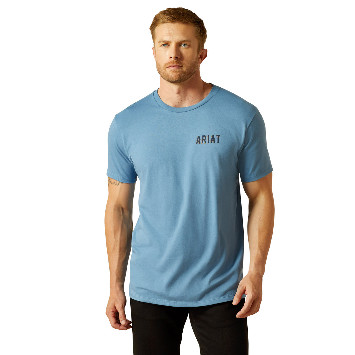 Man wearing a light blue Ariat t-shirt on a white background