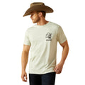 Man wearing a beige t-shirt with a logo and a cowboy hat on a white background