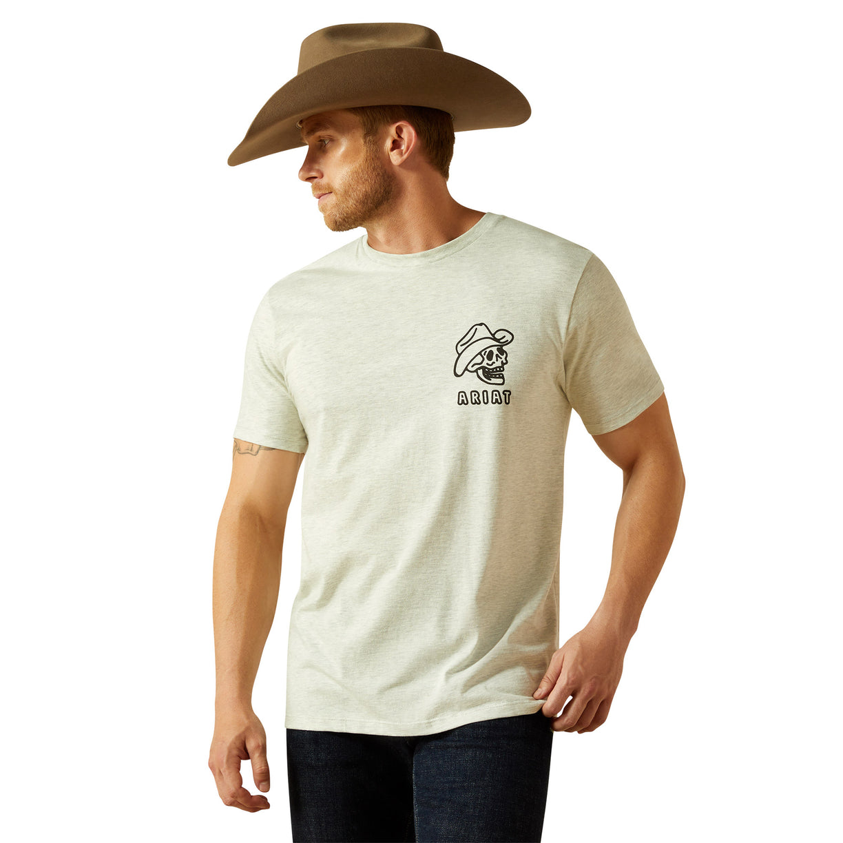 Man wearing a beige t-shirt with a logo and a cowboy hat on a white background