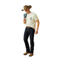 Man wearing a cowboy hat, white t-shirt, dark jeans, and brown boots on a white background